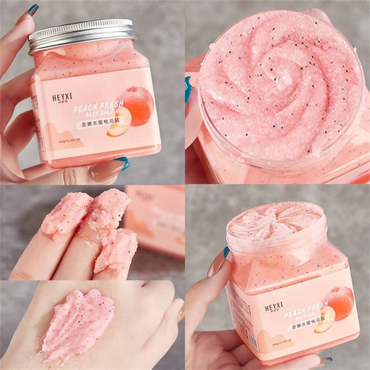 Peach Fresh facial scrub with creamy texture and exfoliating particles in a jar, shown on hand for skincare routine.